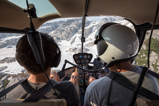 Instructor teaching student how to land helicopter in the alpine terrain.