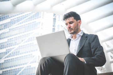 Businessman successful working in city on building background