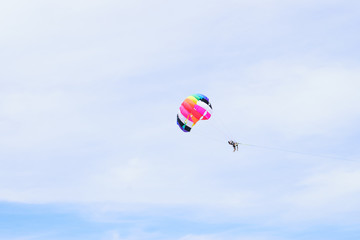 The sky parachute has a blue backdrop background.