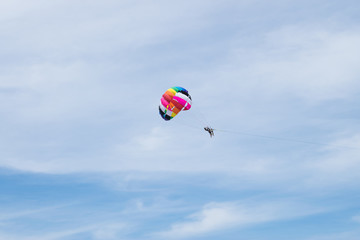 The sky parachute has a blue backdrop background.