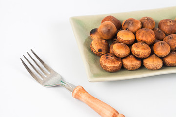 Chestnuts food with fork from rain forest