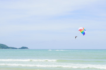 Parachutes in the sky float over the Andaman Sea.