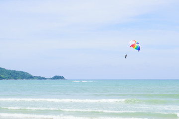 Parachutes in the sky float over the Andaman Sea.