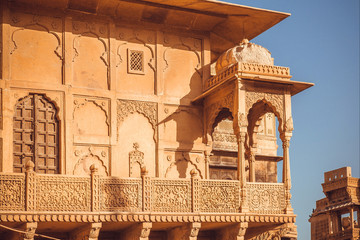 Example of Indian architecture with details of facade of historical house, carved walls, balcony and traditional elements