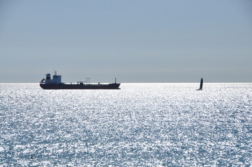 a ship and a sailing boat in a sunny day, Genova, Liguria, Italy