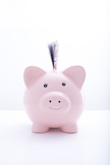 Frontal shot of piggbank with notes