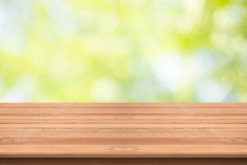 Wood table top on nature green blurred background,for montage your products