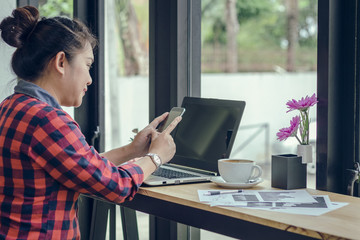 Close Up businessmen working at a coffee shop with a document with a smartphone and a laptop computer Vintage effect.