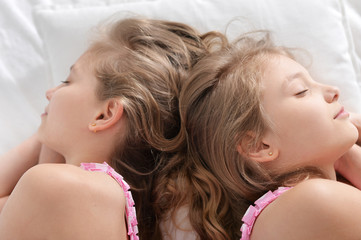 Naklejka premium Cute little girls sleeping