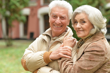 senior couple hugging in park 