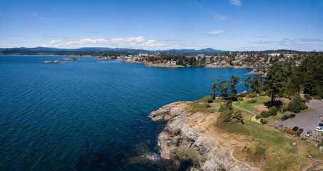 Fototapeta premium Aerial panoramic landscape view of a beautiful rocky shore on Pacific Coast. Taken in Saxe Point Park, Victoria, Vancouver Island, British Columbia, Canada.