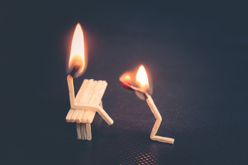 Burning matches, like people. guy kneels in front of the girl and asks for forgiveness....