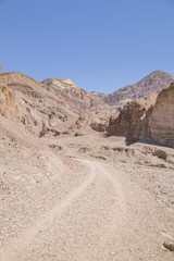 Fototapeta na wymiar A dirt track running through canyons in Death Valley, California