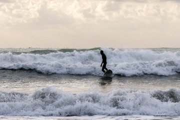 Practicing the sport of surfing