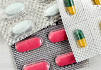 Many colorful capsules and pills in a blister pack