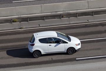 White supermini car on the highway