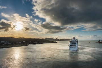 Wide view of distant cruise ship leaving harbor