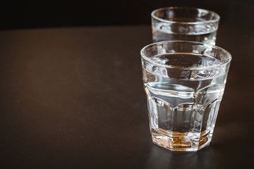 Glass of water on a wooden table