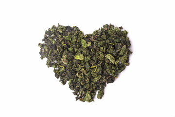 Green tea in the shape of heart isolated on a white background