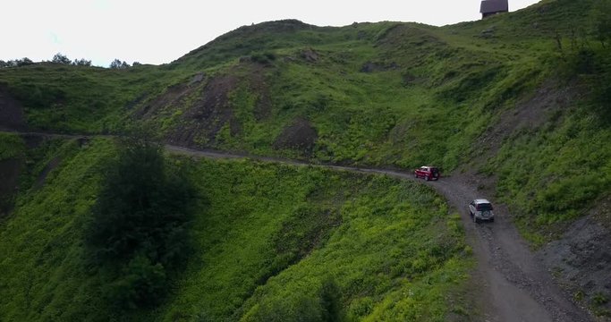 Aerial view. Two suv cars driving on a mountain road