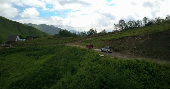 Aerial view. Two jeep cars driving on a mountain road