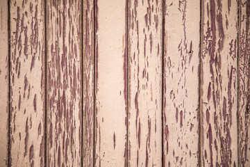 Old and weathered wood panels with peeling red paint
