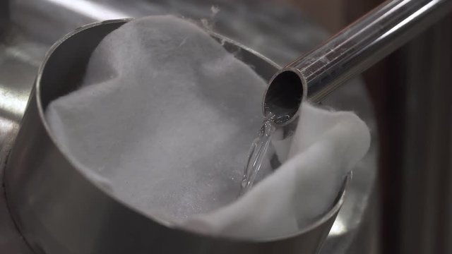 White liquid, Cachaca distillation in cachaca market in Paraty, Rio De Janeiro, Brazil.