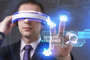 Business, Technology, Internet and network concept. Young businessman working in virtual reality glasses sees the inscription: Quality assurance