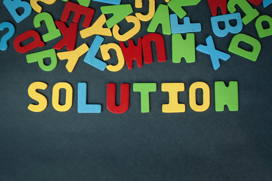 Colorful word solution on a blue background. Business concept.
