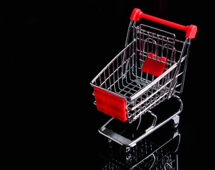 Shopping trolley or cart on black background or isolated