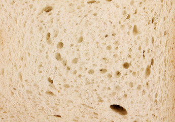 Macro photo. a piece of toast bread close-up, isolated on a wooden background. Maximum...