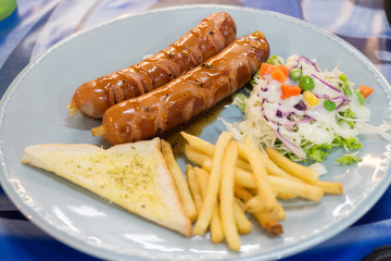 Grilled sausage with sauce and Fresh salad and French fries