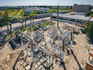 Fototapeta premium Top view of high-voltage substation with switches and disconnectors. Powe plant.