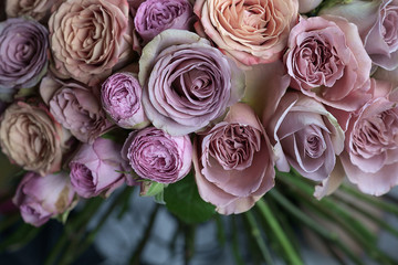 Beautiful pink, violet and peach roses wedding bouquet closeup macro