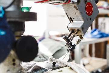 Overlock sewing machine - view on working area and machine front with needle - foreground blanked...