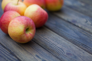 yellow-red apples closeup on wooden background