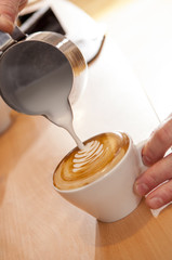 Hot Milk Pouring into Cup of Latte