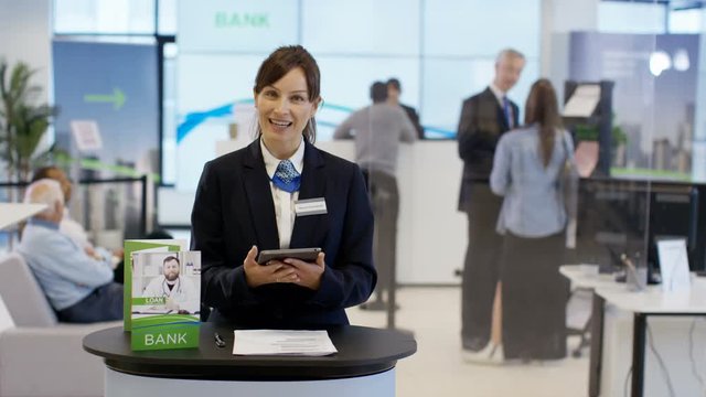  Friendly bank worker talking to customer as seen from customer's pov