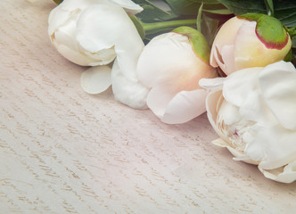 a bouquet of white peonies on paper retro background