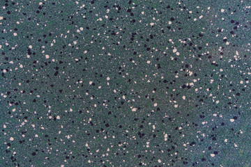 Background or backdrop of ceramic tiles in the style of the starry sky. The texture of the tiles is speckled and dotted.