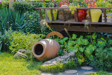 Garden design. Interior flowerbed in the form of a cart and an amorphous phase.