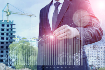 Businessman draws a graph of statistics.