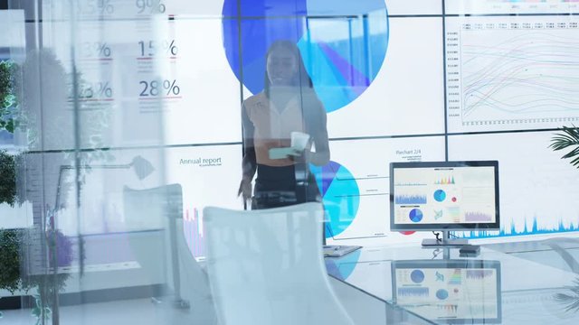  Businesswoman alone in meeting room rehearsing for business presentation