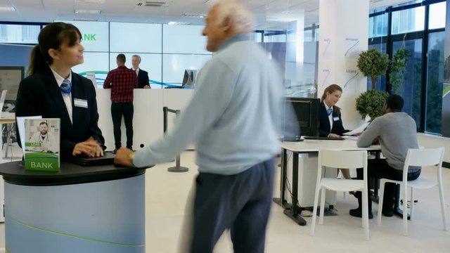  Time lapse of busy modern bank, friendly staff assisting customers