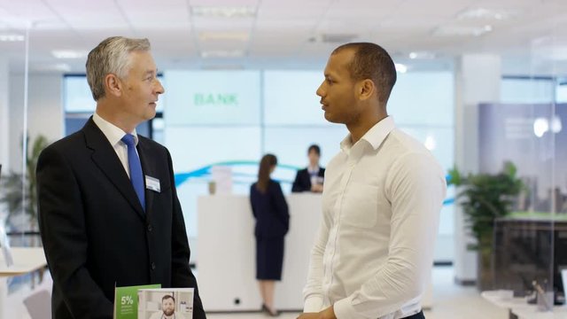  Customers wait to meet with financial adviser in modern bank