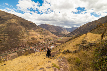 Obraz premium Tourist exploring the Inca Trails and the majestic terraces of Pisac, Sacred Valley, major travel destination in Cusco region, Peru. Vacations and adventures in South America.