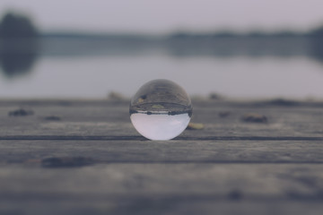 autum landscape at a lake stage shot with a glas sphere 