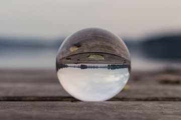 autum landscape at a lake stage shot with a glas sphere 