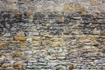 Ancient brick wall with different size of stones.