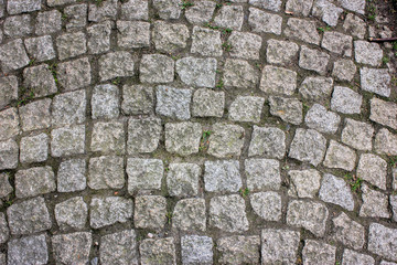 Prague cobblestone gray beige paving stone square background.